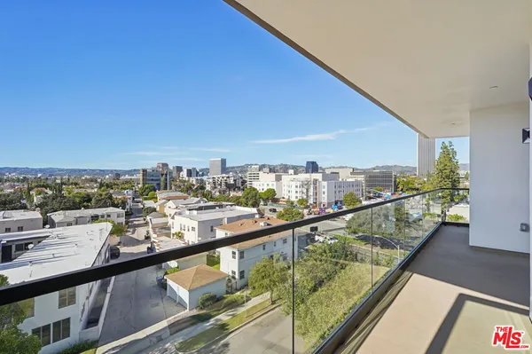 a view of a city from a balcony with outdoor space