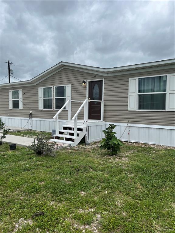 210 Risueno Avenue Donna, TX 78537 - Photo 1 of 32 a backyard of a house with table and chairs