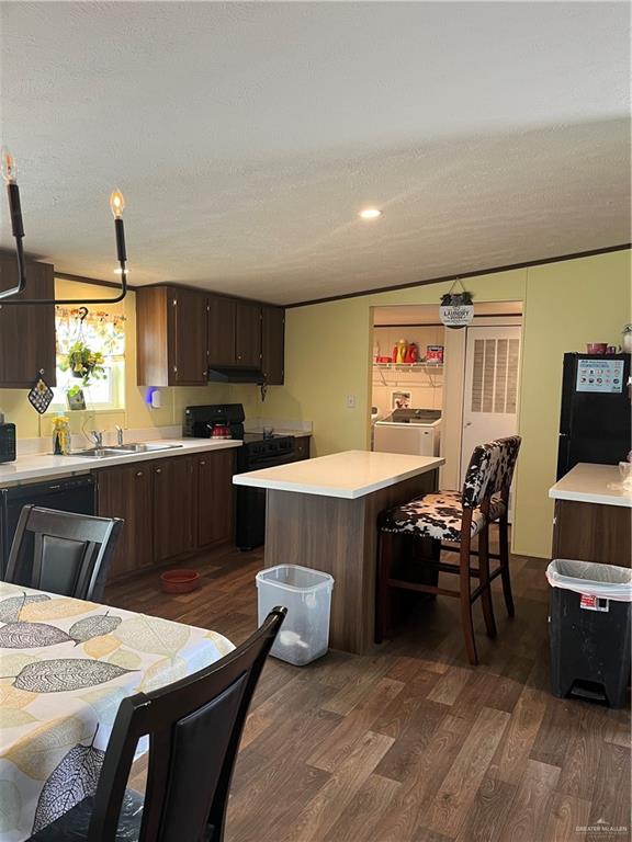 210 Risueno Avenue Donna, TX 78537 - Photo 17 of 32 a kitchen with a table chairs sink and cabinets
