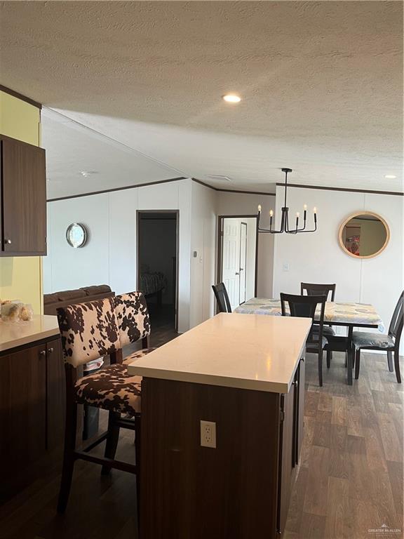 210 Risueno Avenue Donna, TX 78537 - Photo 18 of 32 a kitchen with a table chairs and a refrigerator