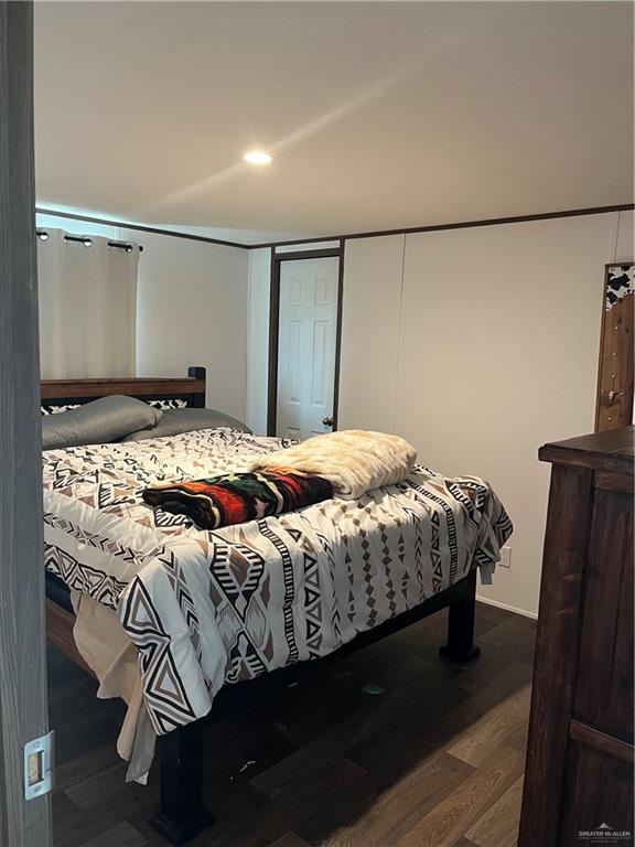 210 Risueno Avenue Donna, TX 78537 - Photo 28 of 32 a bedroom with a bed and a mirror