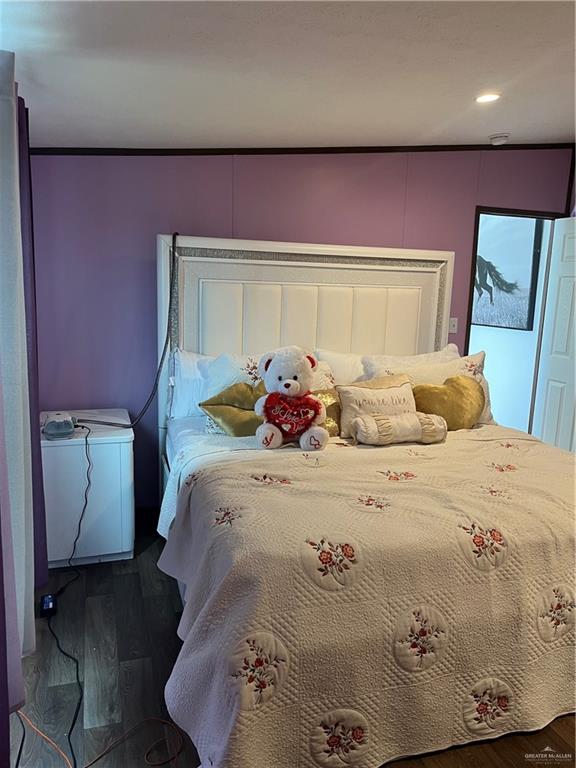 210 Risueno Avenue Donna, TX 78537 - Photo 29 of 32 a bedroom with a bed and wooden floor