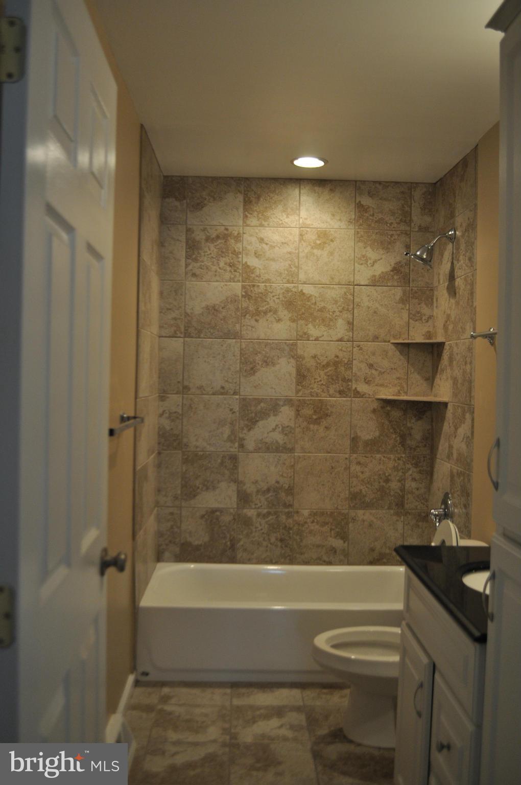 929 Woodlynn Road Baltimore, MD 21221 - Photo 13 of 25 a bathroom with a bathtub and a shower