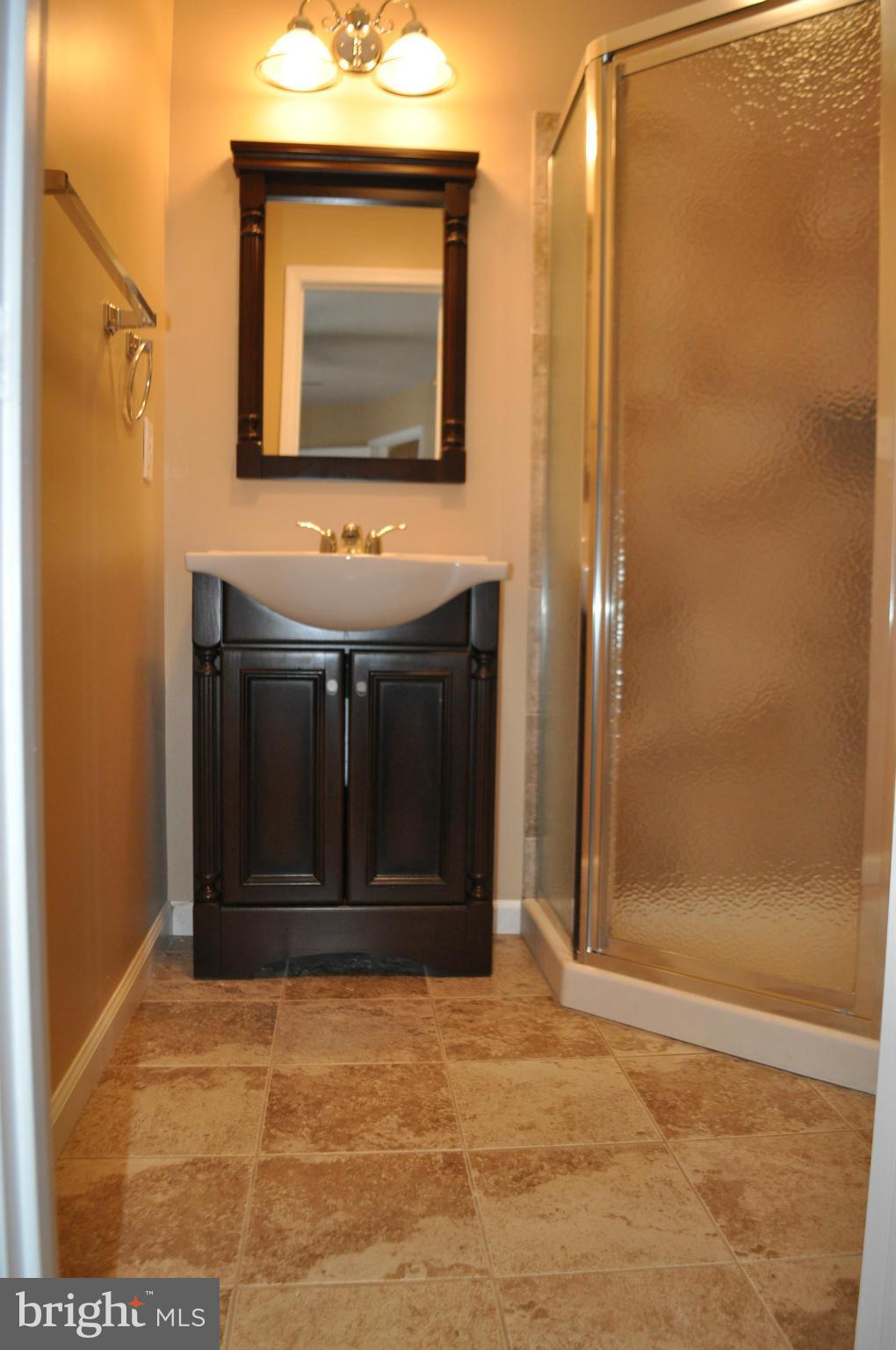 929 Woodlynn Road Baltimore, MD 21221 - Photo 15 of 25 a bathroom with a granite countertop sink and a mirror