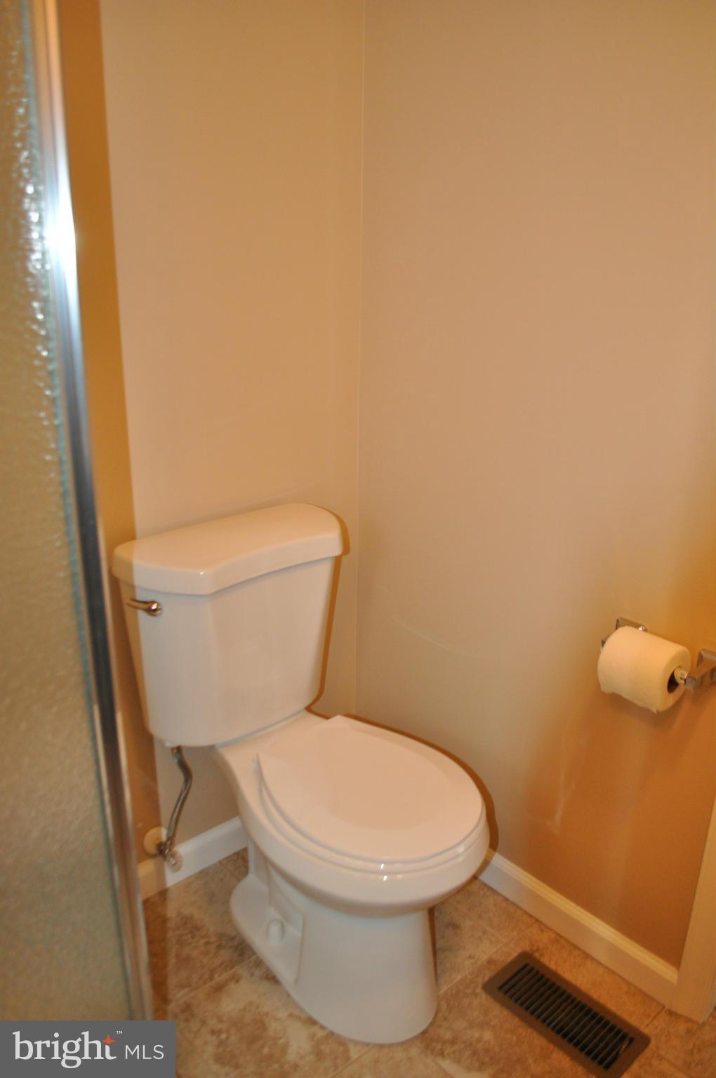 929 Woodlynn Road Baltimore, MD 21221 - Photo 17 of 25 a white toilet sitting next to a shower