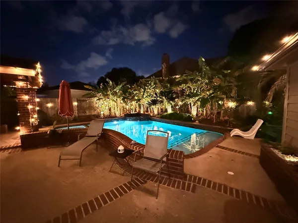 a view of a swimming pool with an outdoor space and seating area