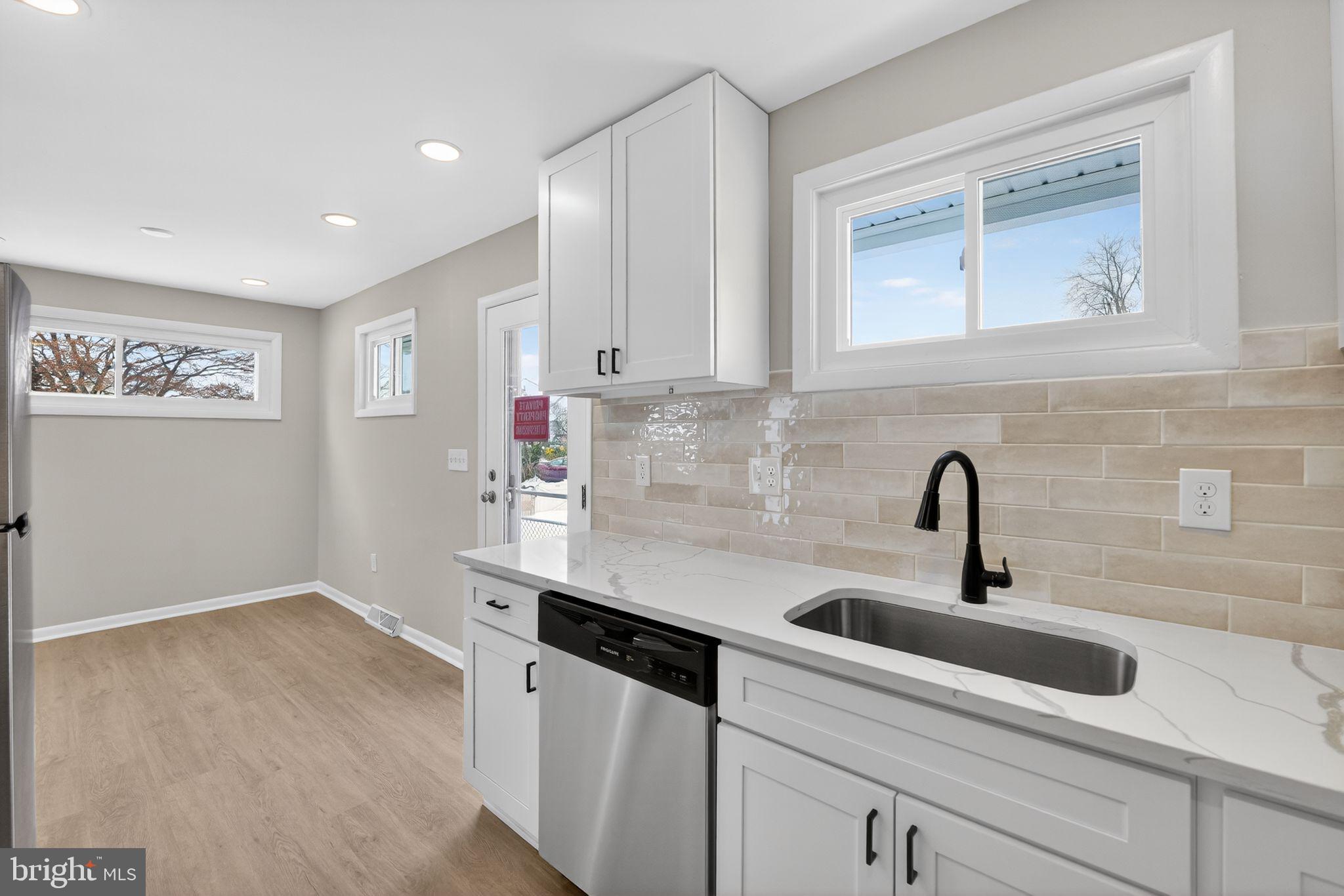 203 Antietam Road Baltimore, MD 21221 - Photo 12 of 33 a kitchen with a sink and cabinets