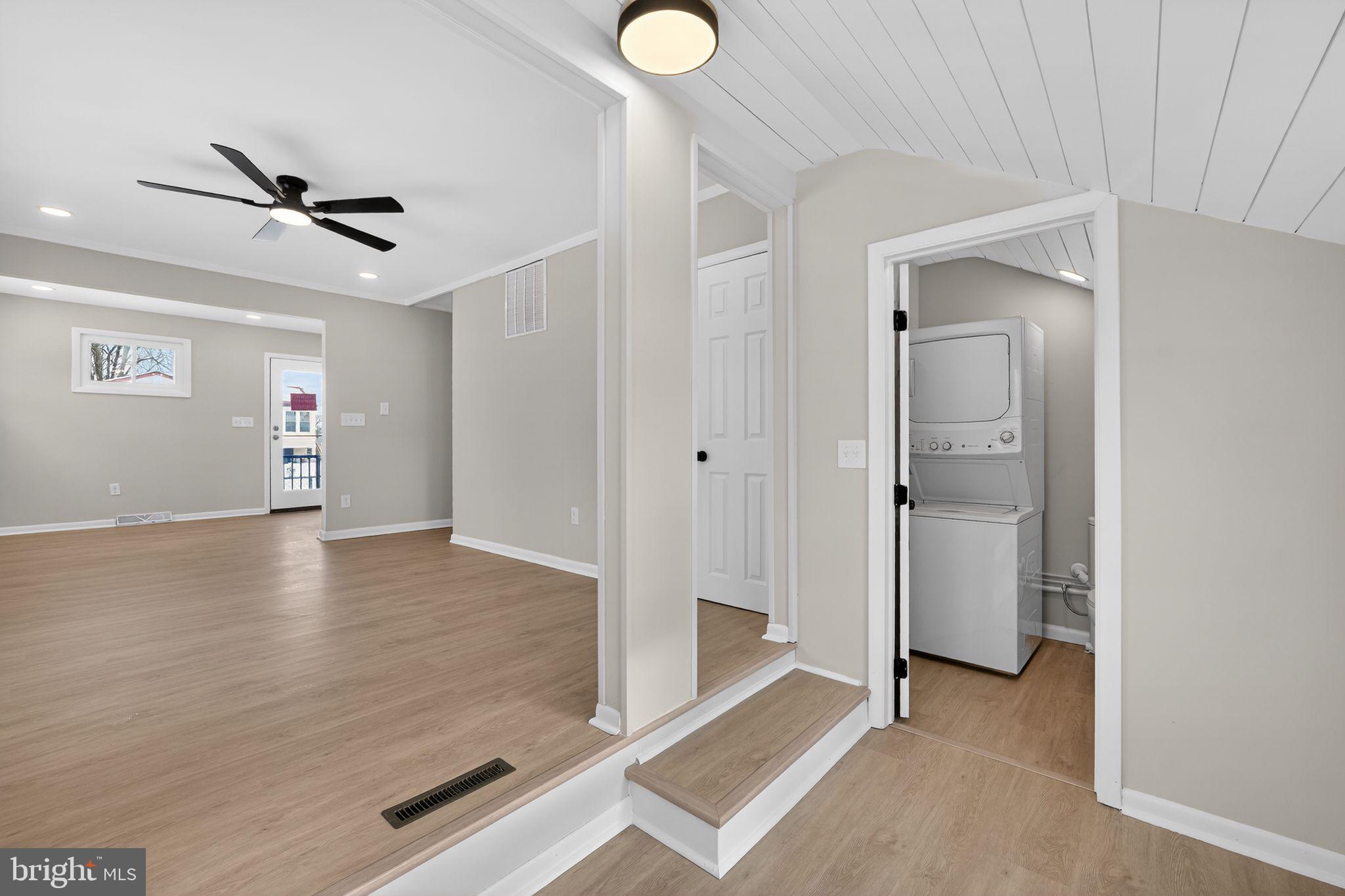 203 Antietam Road Baltimore, MD 21221 - Photo 14 of 33 a view of a livingroom with wooden floor and ceiling fan