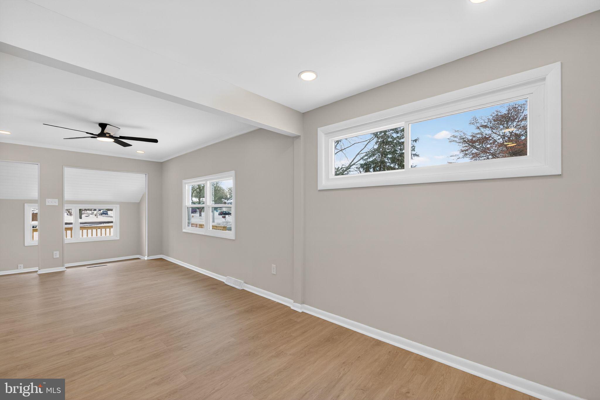 203 Antietam Road Baltimore, MD 21221 - Photo 16 of 33 a view of an empty room with window and wooden floor