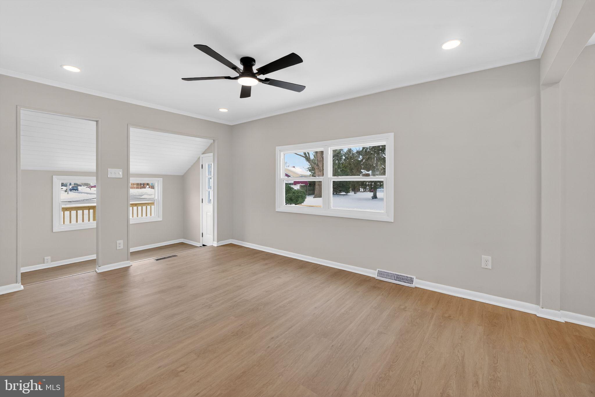 203 Antietam Road Baltimore, MD 21221 - Photo 17 of 33 a view of an empty room with wooden floor and a window