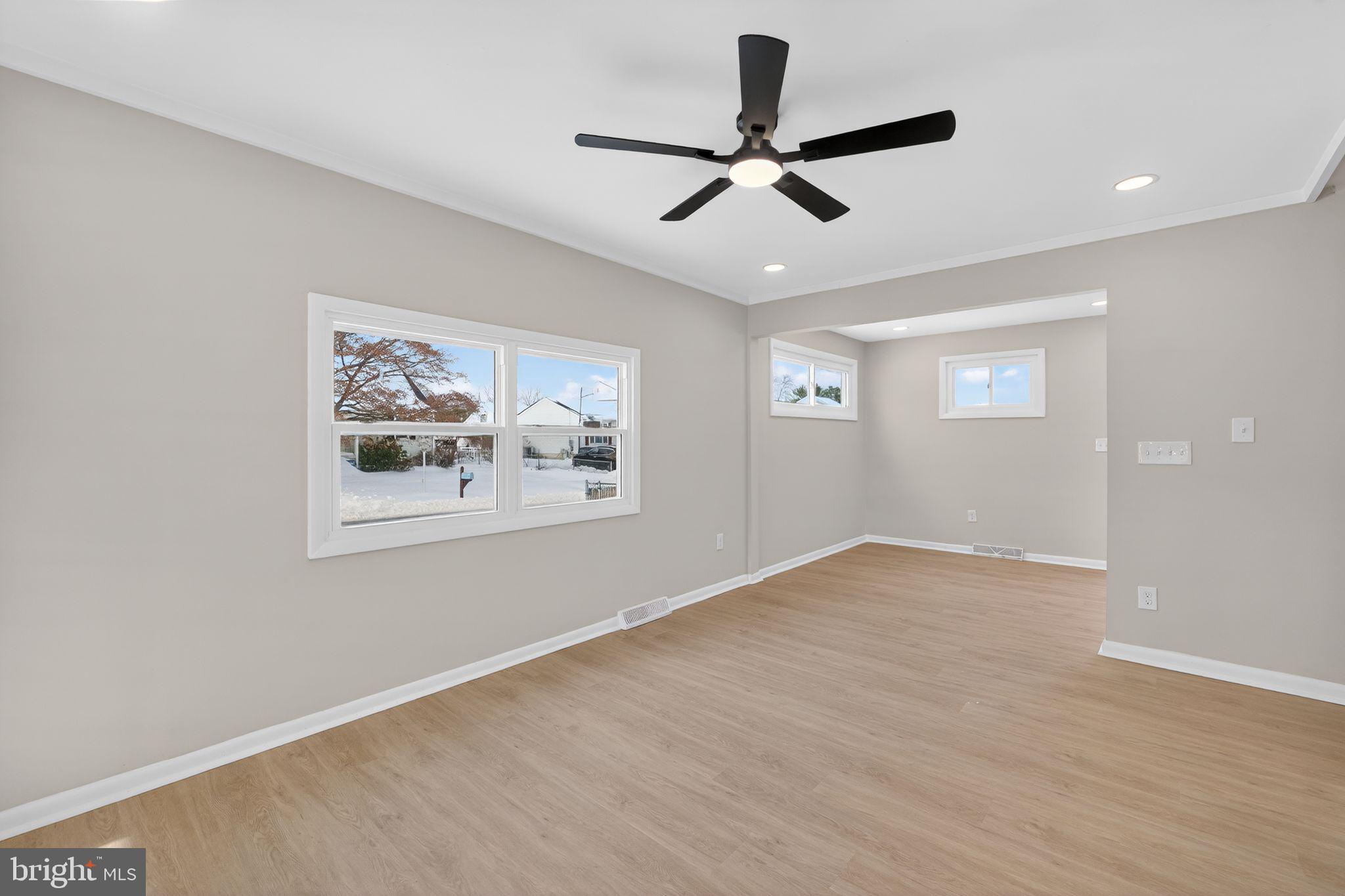 203 Antietam Road Baltimore, MD 21221 - Photo 25 of 33 a view of a big room with wooden floor and windows