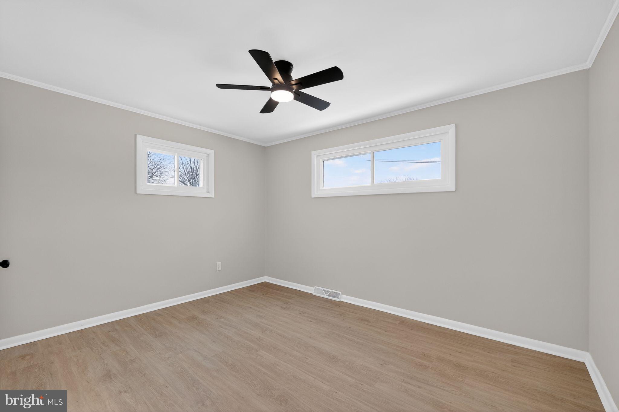 203 Antietam Road Baltimore, MD 21221 - Photo 27 of 33 a view of a big room with wooden floor and windows