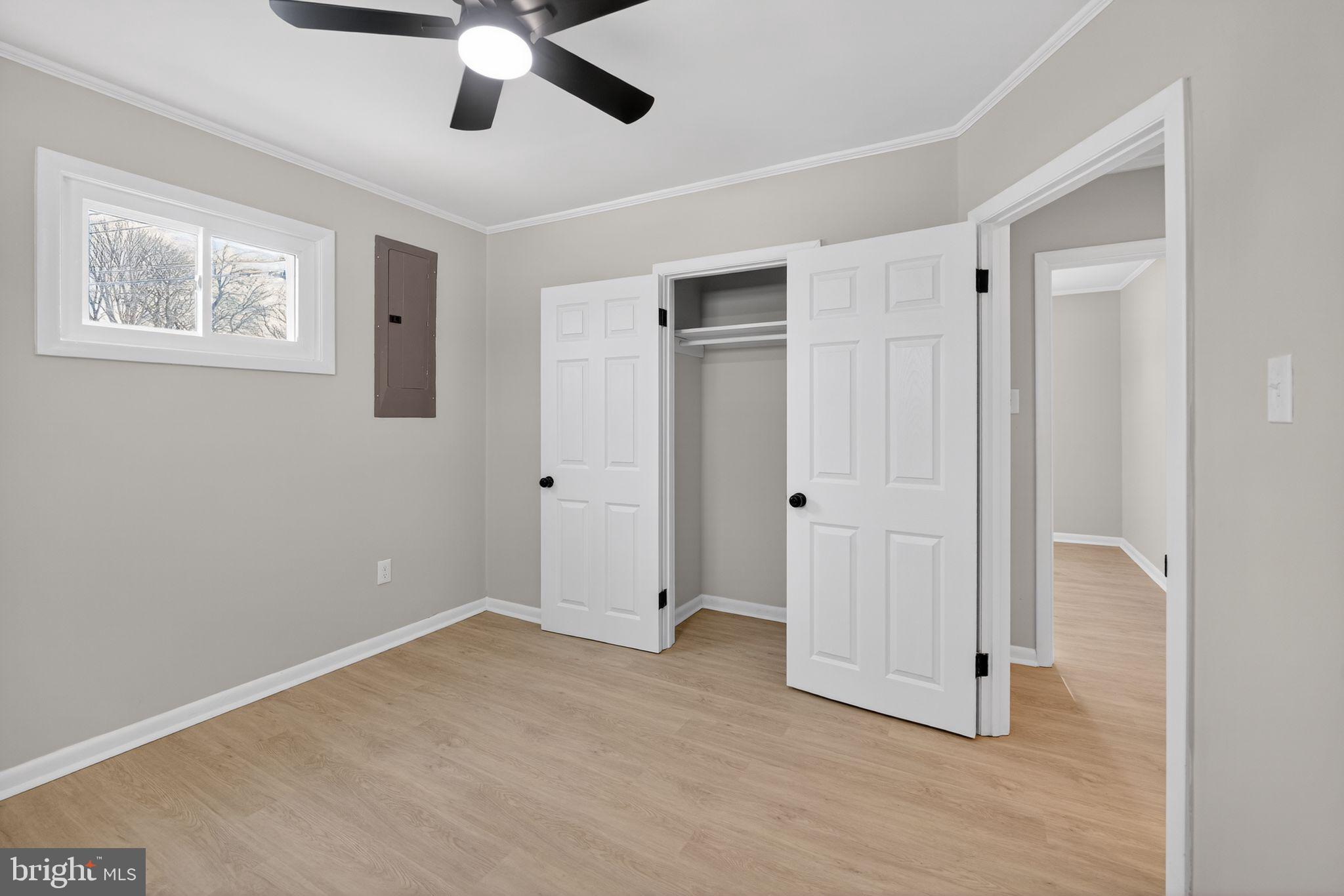 203 Antietam Road Baltimore, MD 21221 - Photo 31 of 33 a view of empty room with wooden floor and ceiling fan