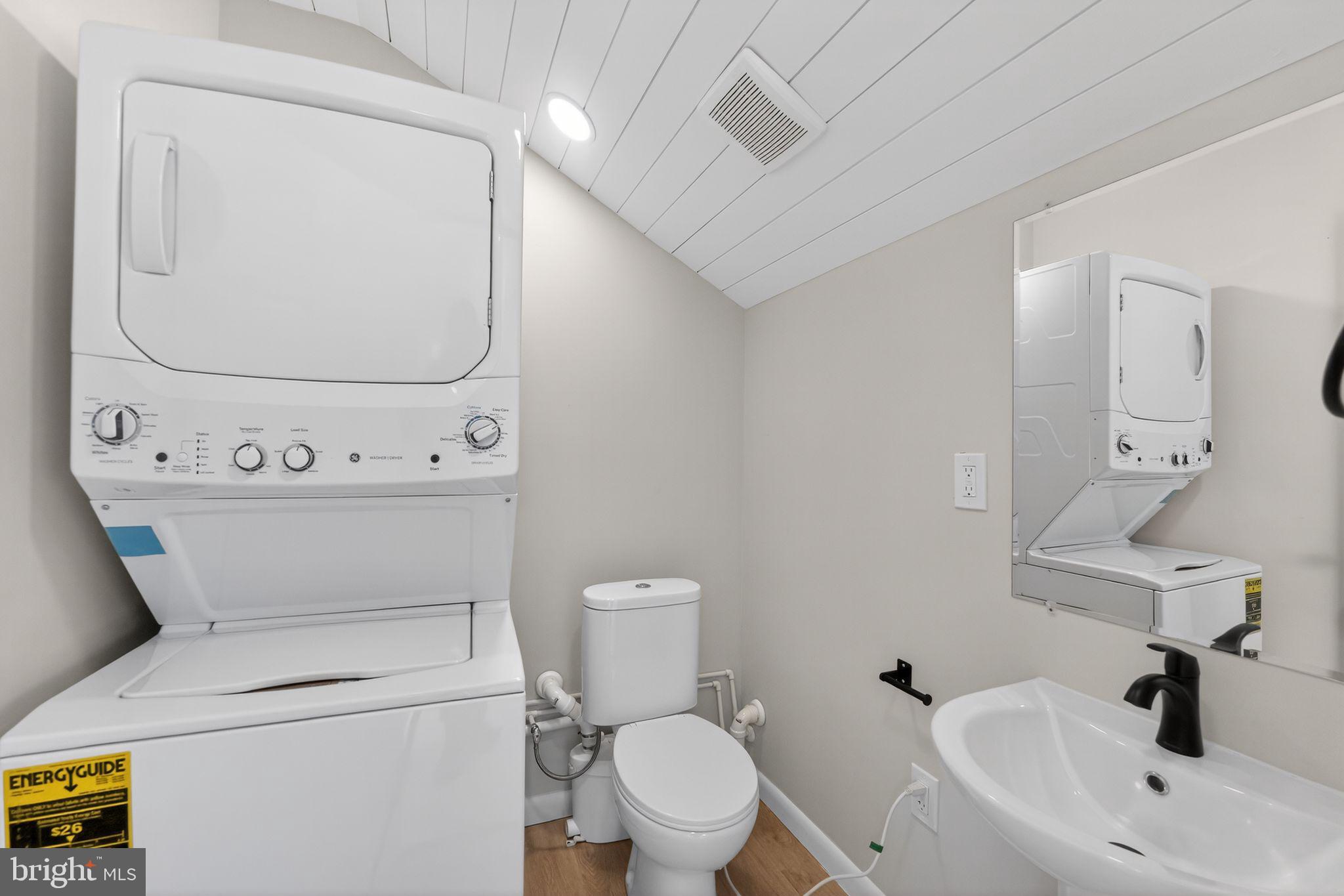 203 Antietam Road Baltimore, MD 21221 - Photo 32 of 33 a bathroom with a toilet sink and mirror