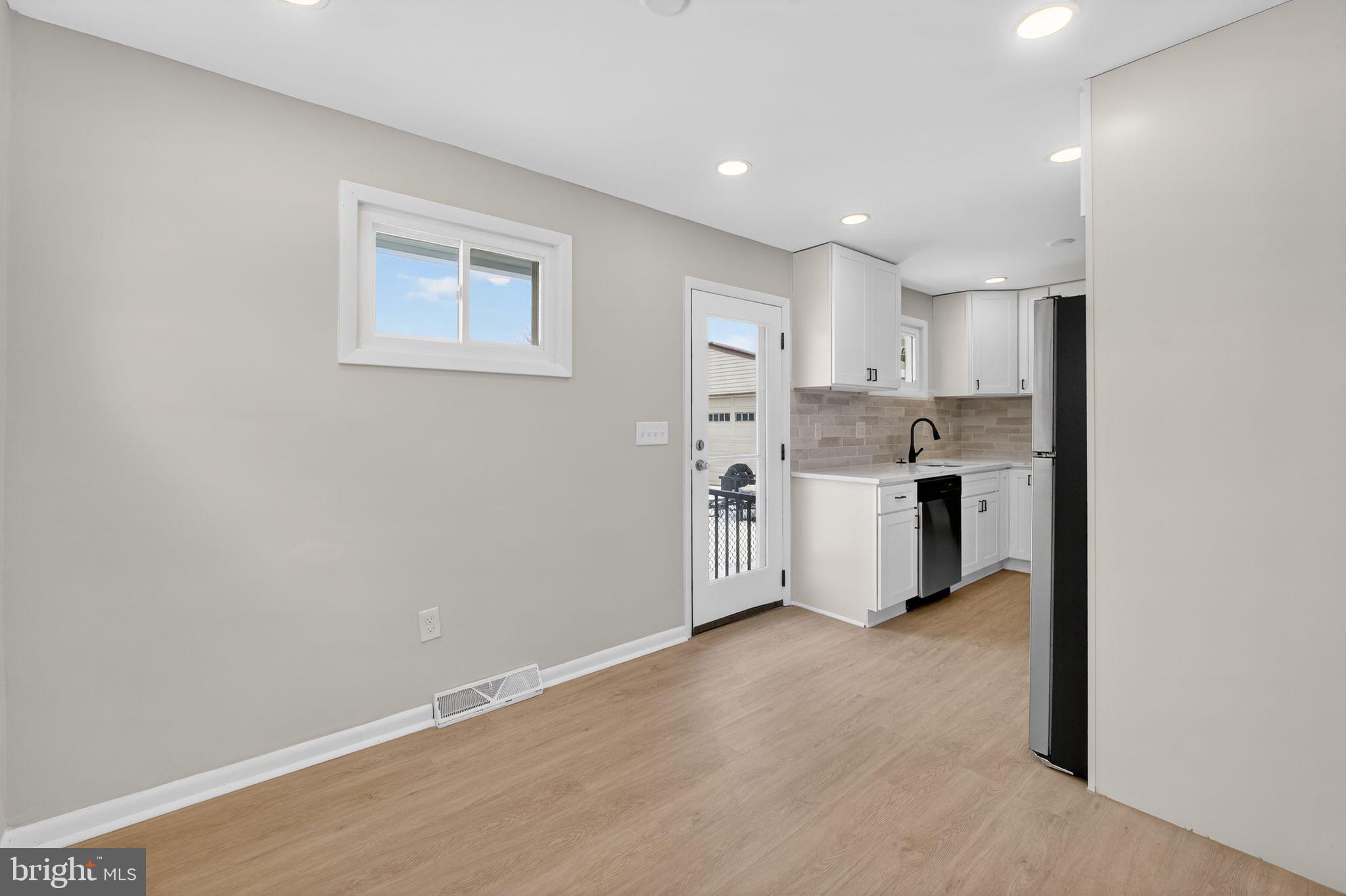 203 Antietam Road Baltimore, MD 21221 - Photo 9 of 33 a view of a kitchen with a sink cabinets and a window