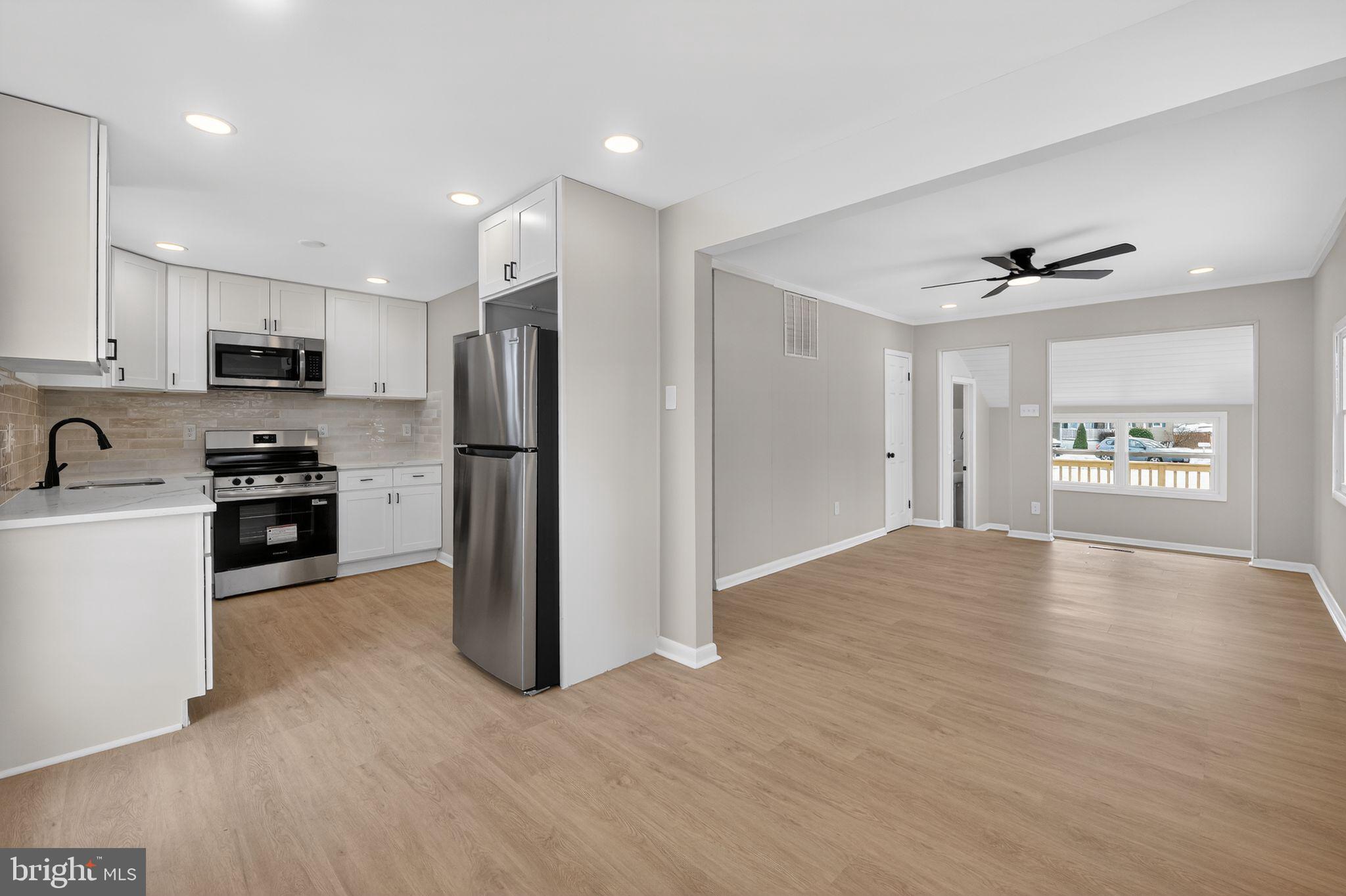 203 Antietam Road Baltimore, MD 21221 - Photo 10 of 33 a view of kitchen with refrigerator stove and wooden cabinets