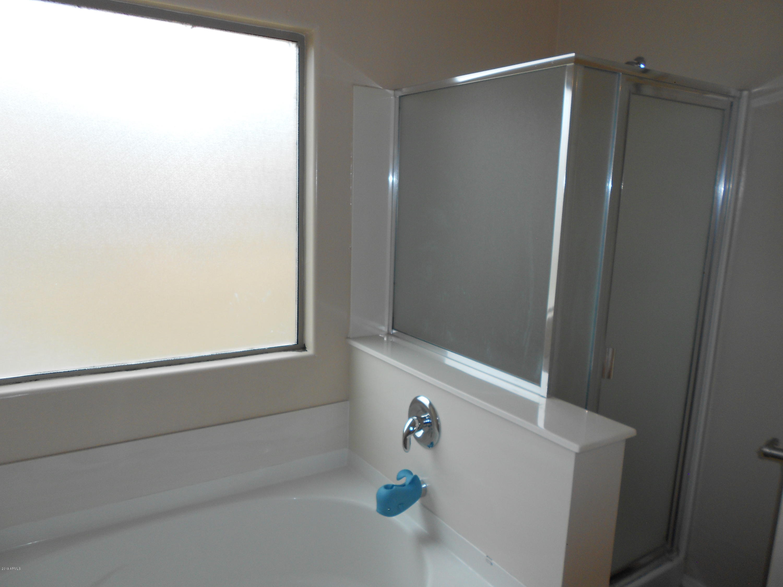 17466 West Boca Raton Road Surprise, AZ 85388 - Photo 13 of 16 a bathroom with a shower and a sink