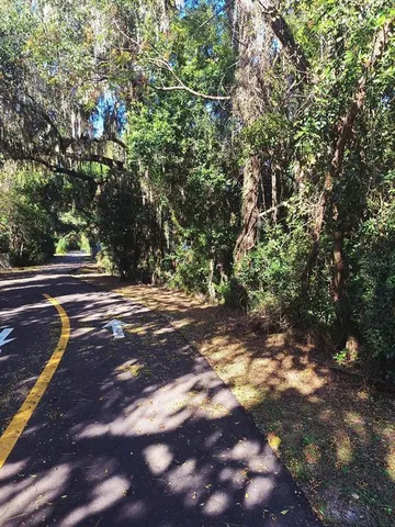 a view of a street with a yard