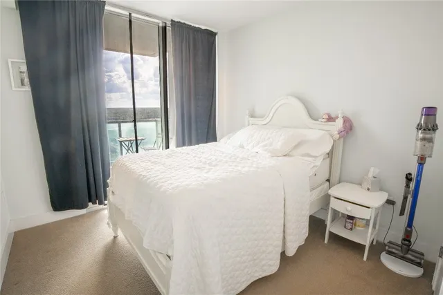 a spacious bedroom with a bed and a table in it