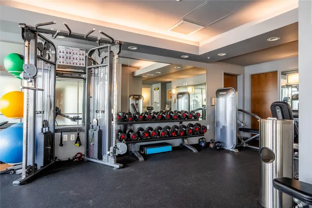 a view of a livingroom with furniture and gym equipment