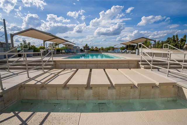 a view of swimming pool with outdoor seating and city view