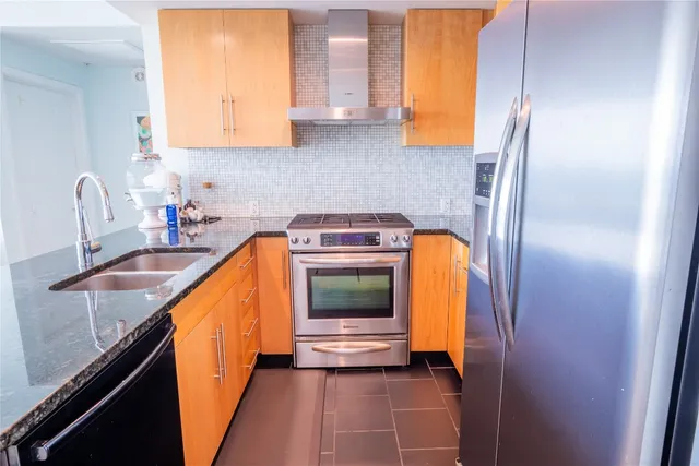 a kitchen with a sink and a refrigerator