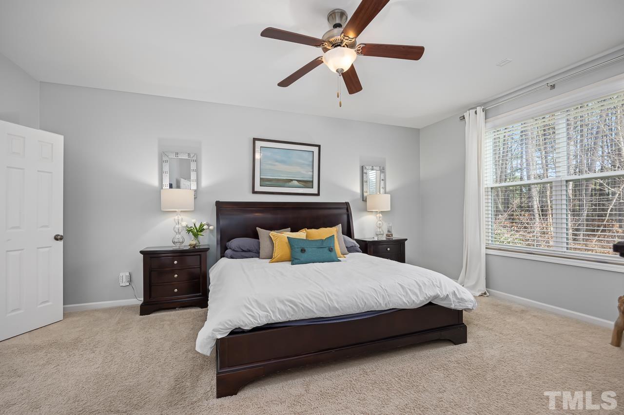 2901 Red Grape Drive Raleigh, NC 27607 - Photo 14 of 43 a spacious bedroom with a bed and a chandelier