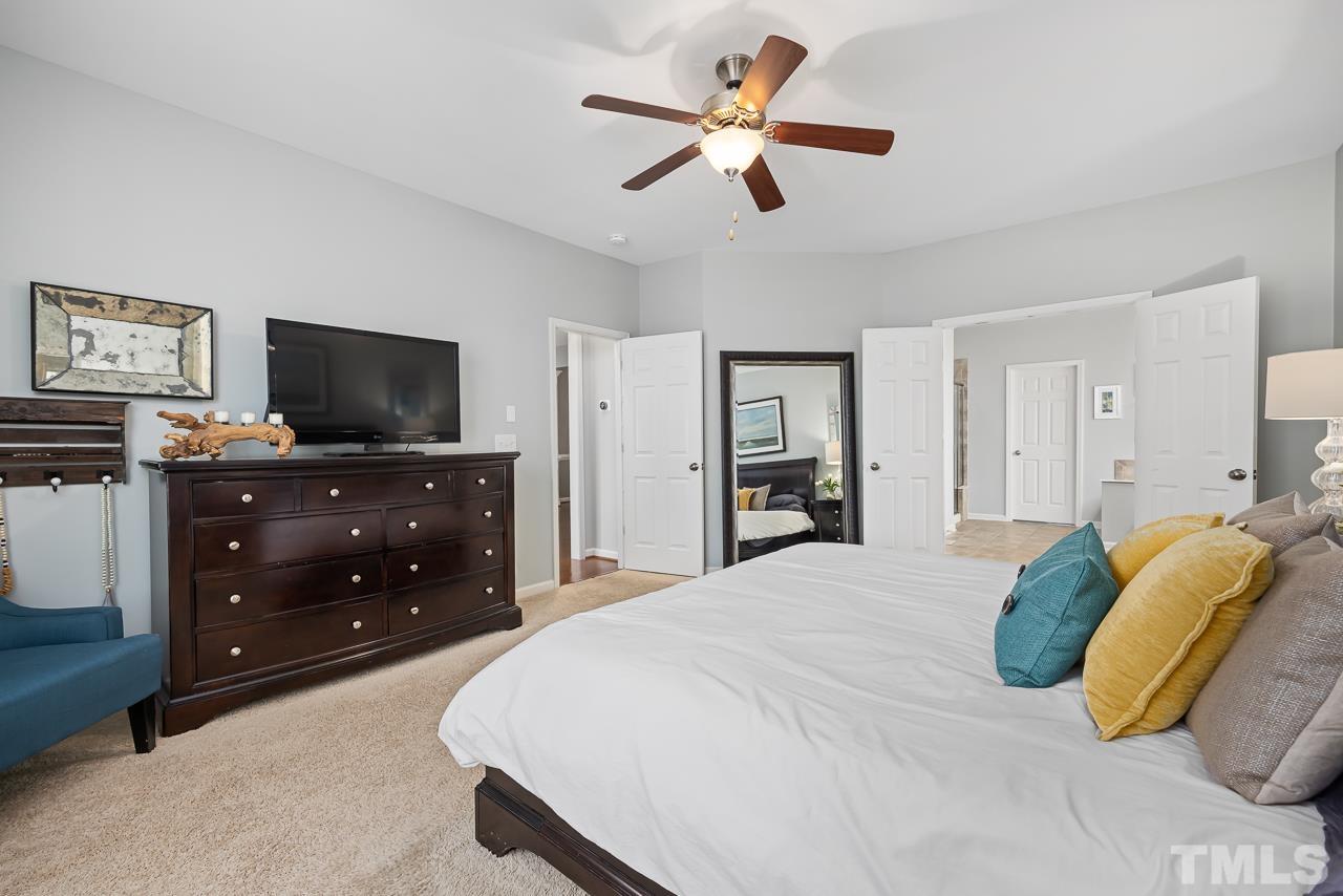 2901 Red Grape Drive Raleigh, NC 27607 - Photo 15 of 43 a bedroom with a bed and a flat screen tv