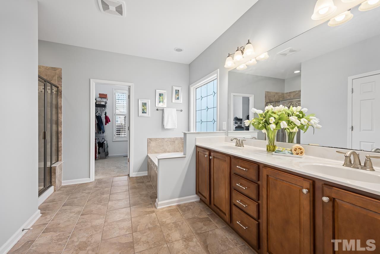 2901 Red Grape Drive Raleigh, NC 27607 - Photo 16 of 43 a spacious bathroom with a double vanity sink mirror and shower