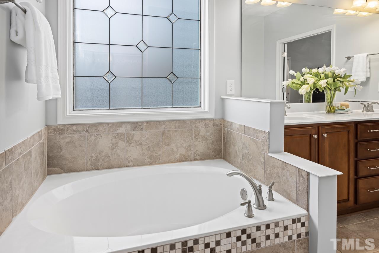 2901 Red Grape Drive Raleigh, NC 27607 - Photo 18 of 43 a bathroom with a bathtub and a shower