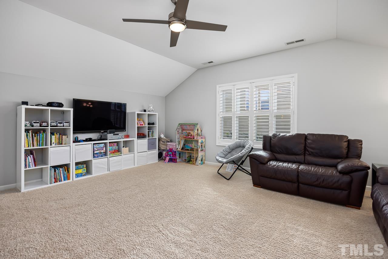 2901 Red Grape Drive Raleigh, NC 27607 - Photo 21 of 43 a living room with furniture and a flat screen tv