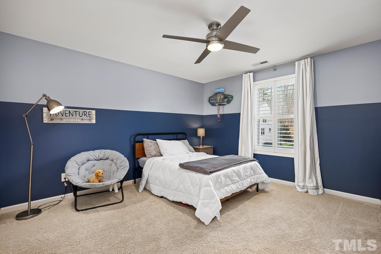 2901 Red Grape Drive Raleigh, NC 27607 - Photo 22 of 43 a bedroom with a bed and a ceiling fan