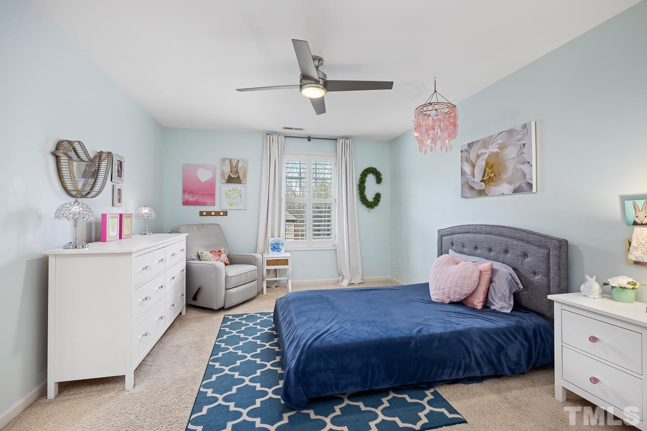 2901 Red Grape Drive Raleigh, NC 27607 - Photo 23 of 43 a bedroom with a bed and a chandelier