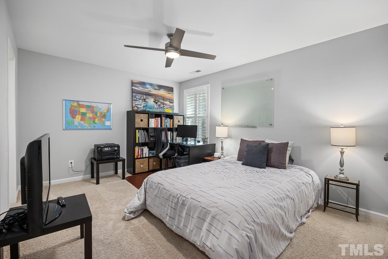 2901 Red Grape Drive Raleigh, NC 27607 - Photo 25 of 43 a bedroom with bed and a flat tv screen