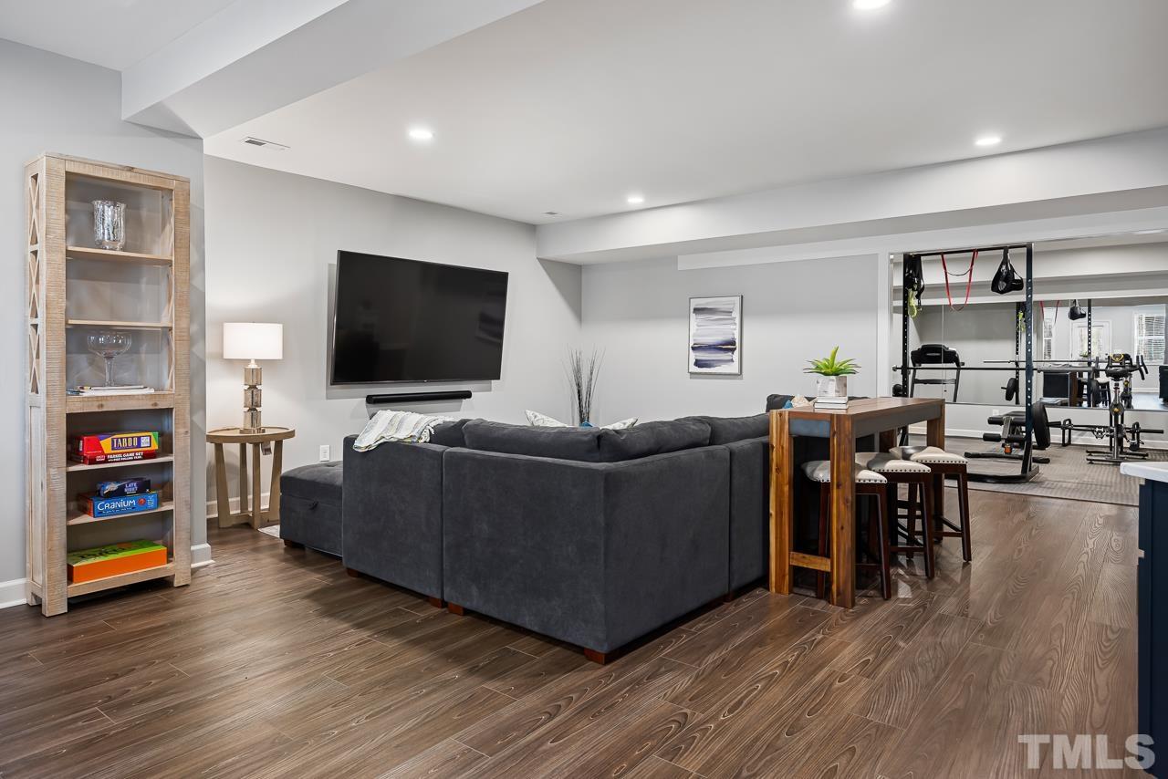 2901 Red Grape Drive Raleigh, NC 27607 - Photo 29 of 43 a living room with furniture and a flat screen tv