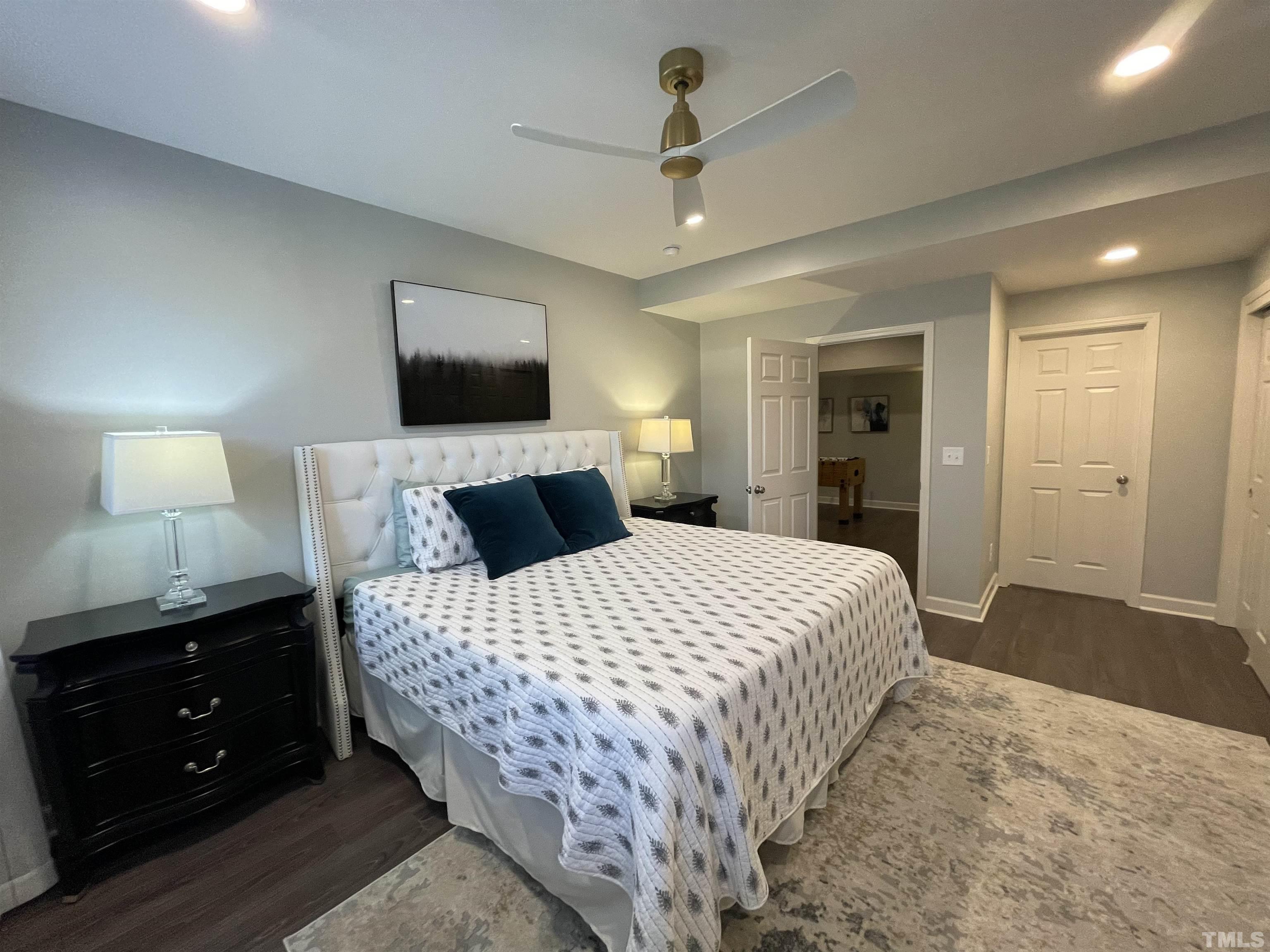 2901 Red Grape Drive Raleigh, NC 27607 - Photo 34 of 43 a bedroom with a bed and a flat tv screen on dresser