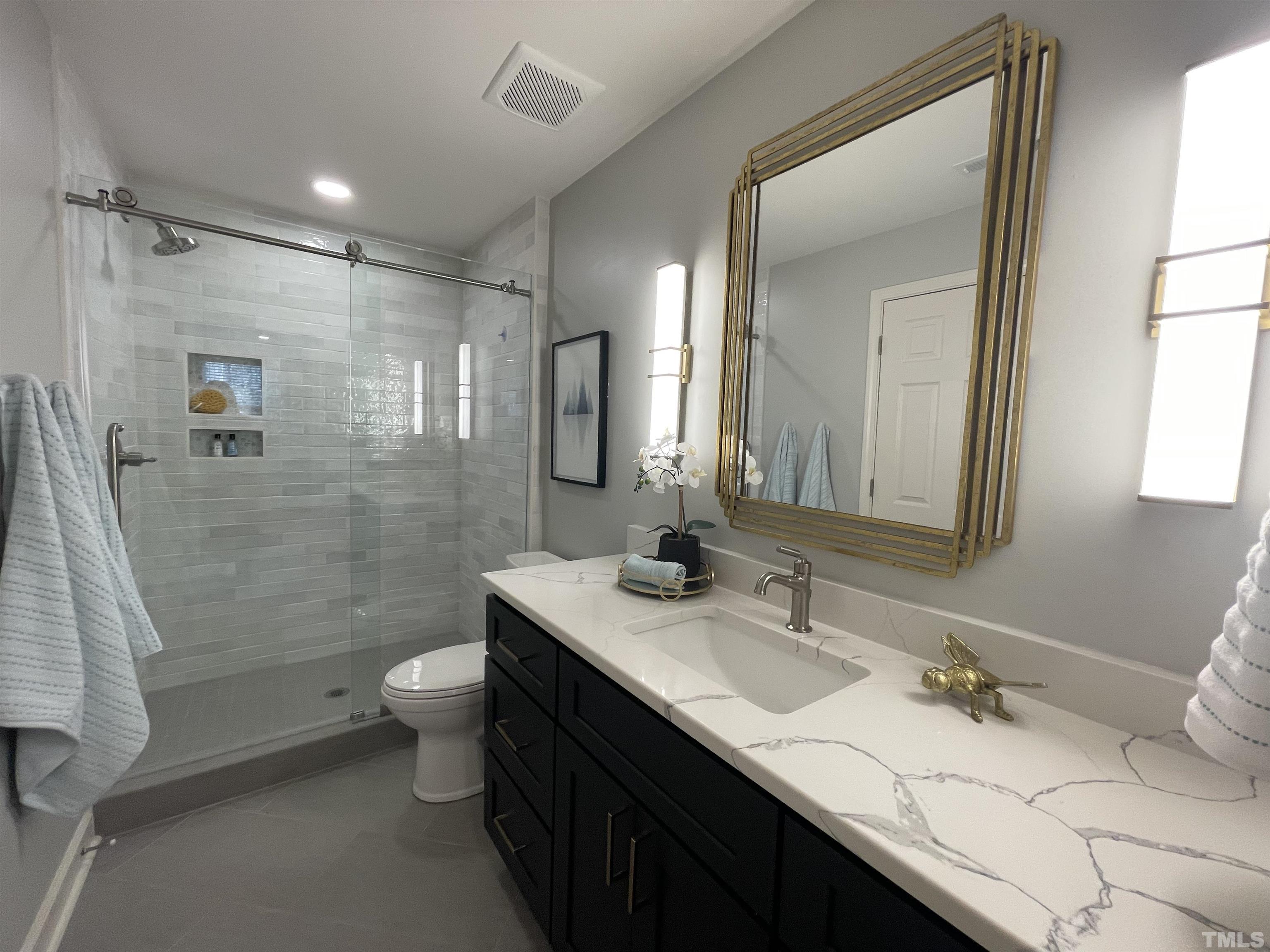 2901 Red Grape Drive Raleigh, NC 27607 - Photo 35 of 43 a bathroom with a sink and a mirror