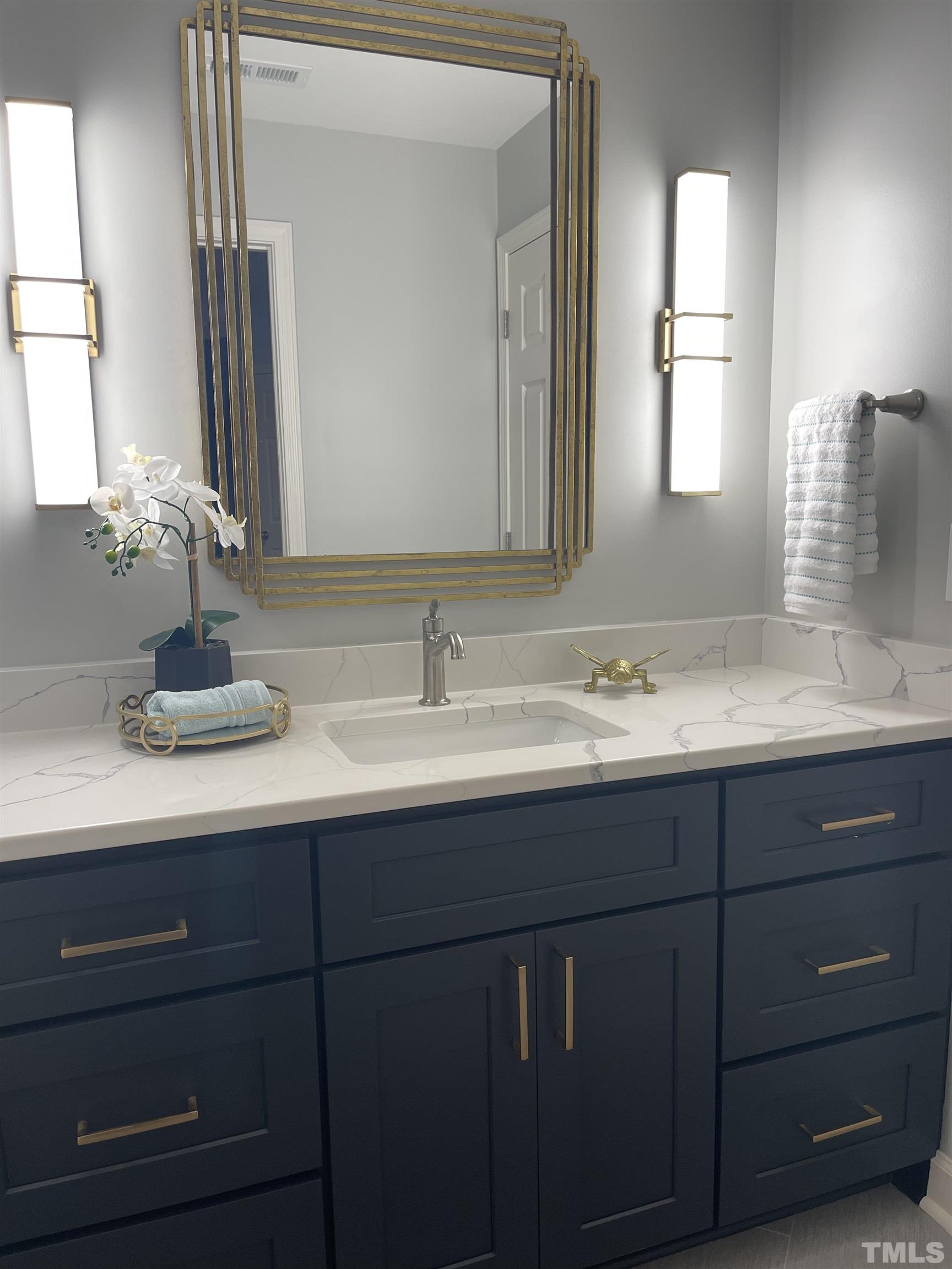 2901 Red Grape Drive Raleigh, NC 27607 - Photo 36 of 43 a bathroom with a double vanity sink and a mirror