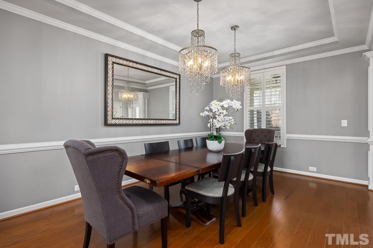 2901 Red Grape Drive Raleigh, NC 27607 - Photo 6 of 43 a dining room with furniture a chandelier and wooden floor