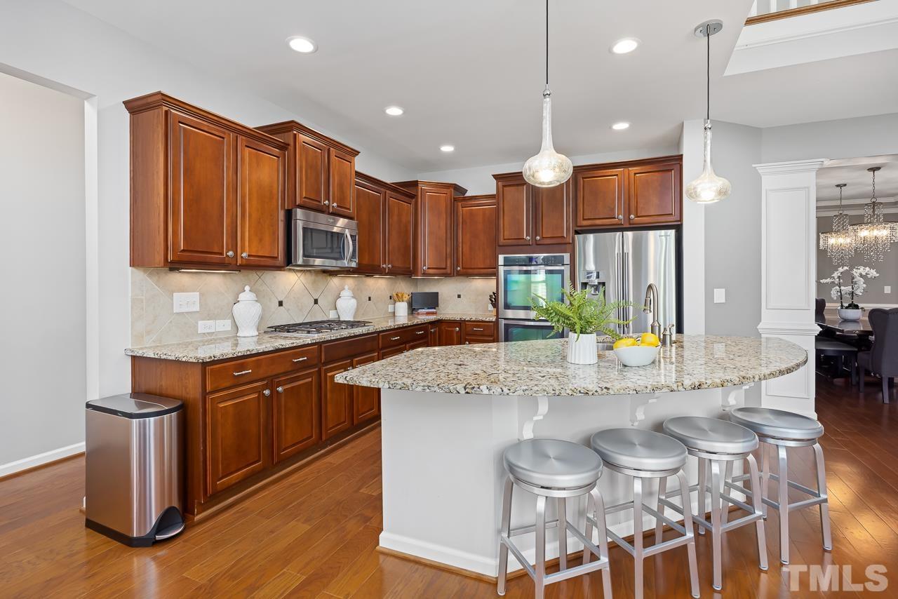 2901 Red Grape Drive Raleigh, NC 27607 - Photo 8 of 43 a kitchen with stainless steel appliances granite countertop a sink a stove a refrigerator and a microwave
