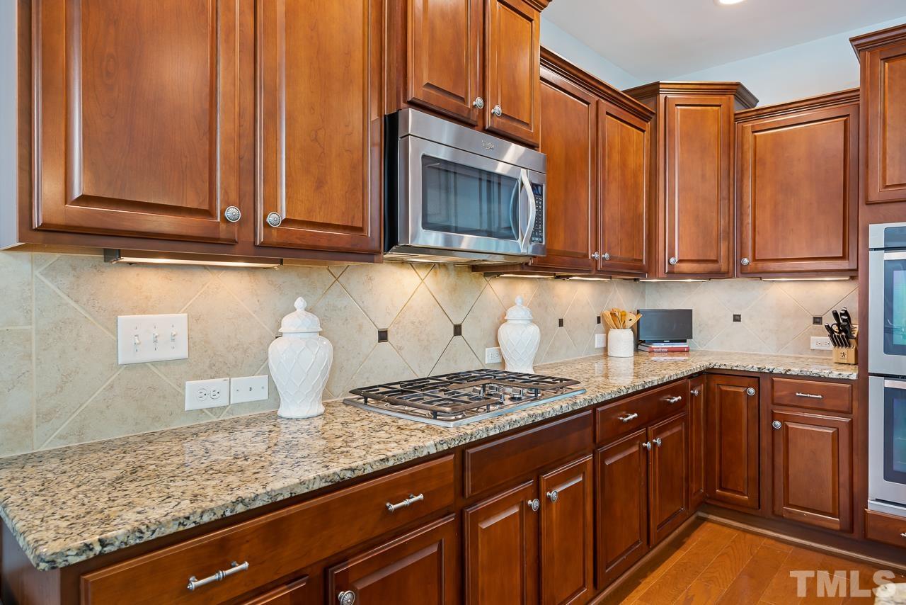 2901 Red Grape Drive Raleigh, NC 27607 - Photo 9 of 43 a kitchen with stainless steel appliances granite countertop a sink a stove and cabinets