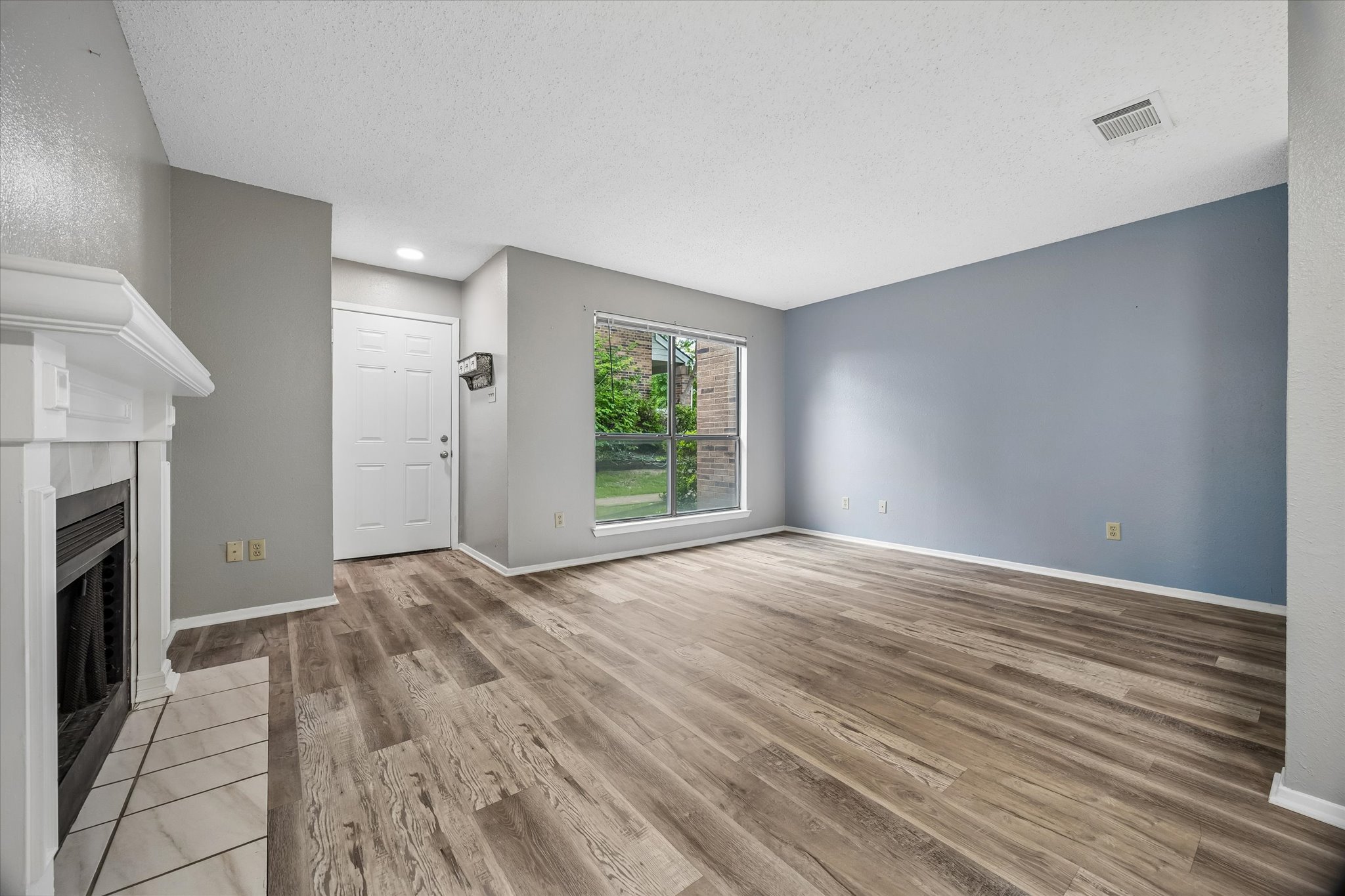2018 West Rundberg Lane, Unit 13A Austin, TX 78758 - Photo 2 of 11 a view of an empty room with window and fireplace