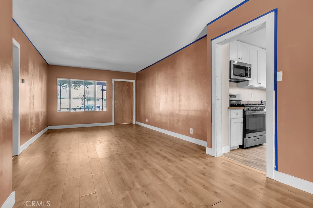 9734 Terradell Street Pico Rivera, CA 90660 - Photo 3 of 10 wooden floor in an empty room with a window