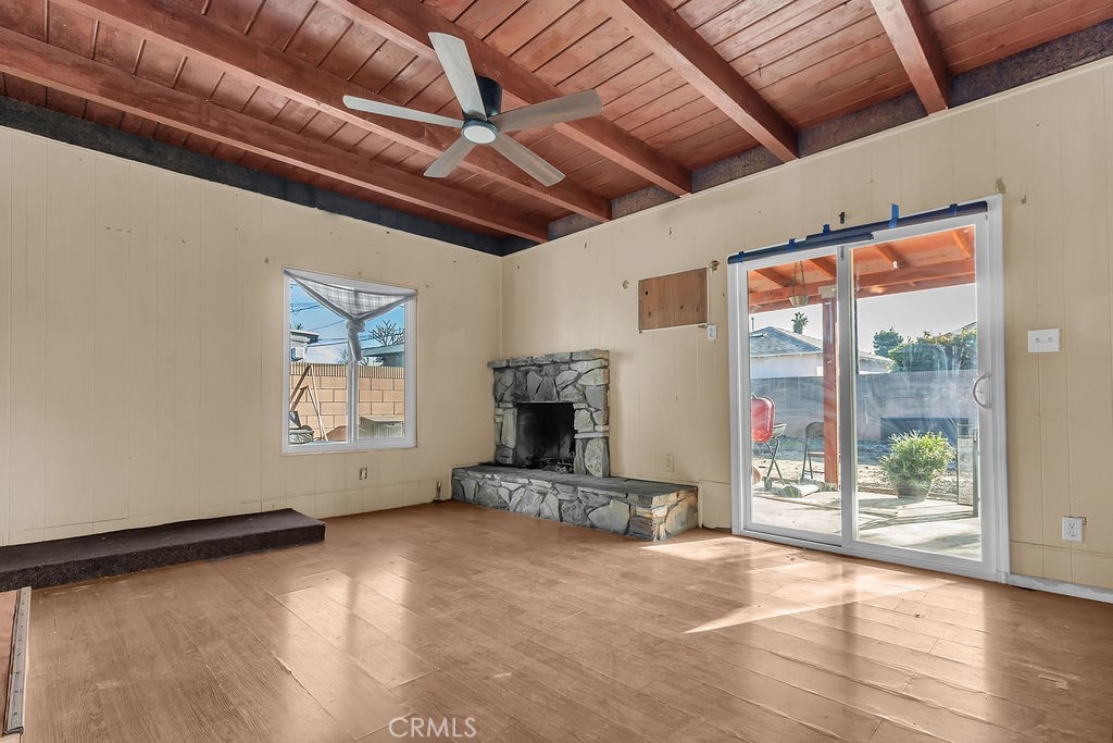 9734 Terradell Street Pico Rivera, CA 90660 - Photo 5 of 10 a view of an empty room with a fireplace and a window