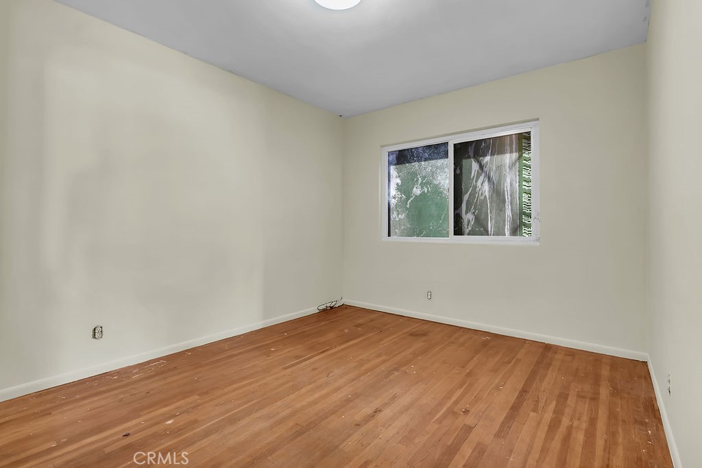 9734 Terradell Street Pico Rivera, CA 90660 - Photo 7 of 10 a view of empty room with wooden floor and fan