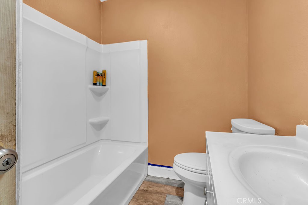 9734 Terradell Street Pico Rivera, CA 90660 - Photo 8 of 10 a white toilet sitting next to a bath tub