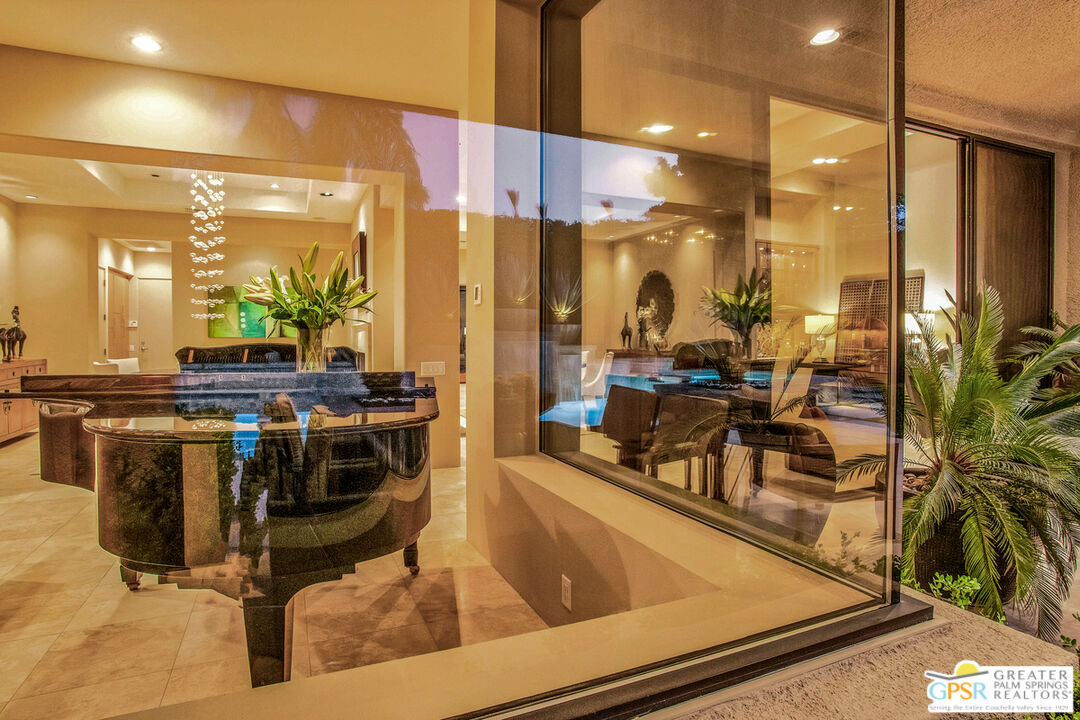 39700 Keenan Drive Rancho Mirage, CA 92270 - Photo 11 of 69 a room with lots of chairs and mirrors