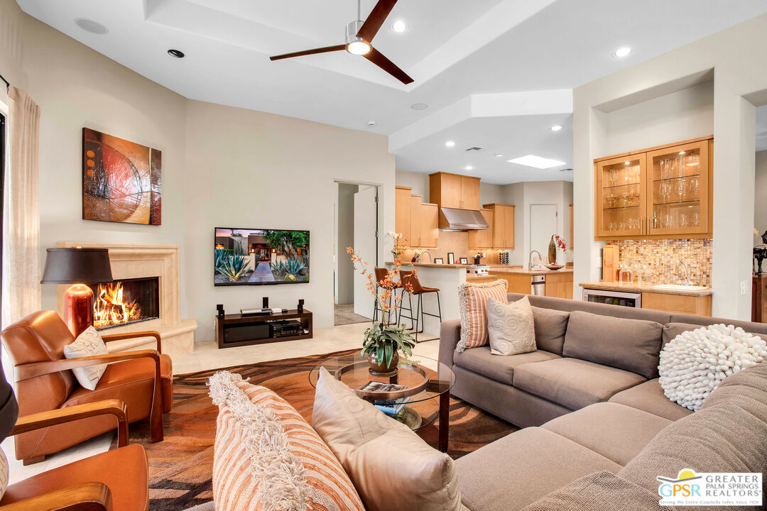 39700 Keenan Drive Rancho Mirage, CA 92270 - Photo 35 of 69 a living room with furniture kitchen view and a fireplace