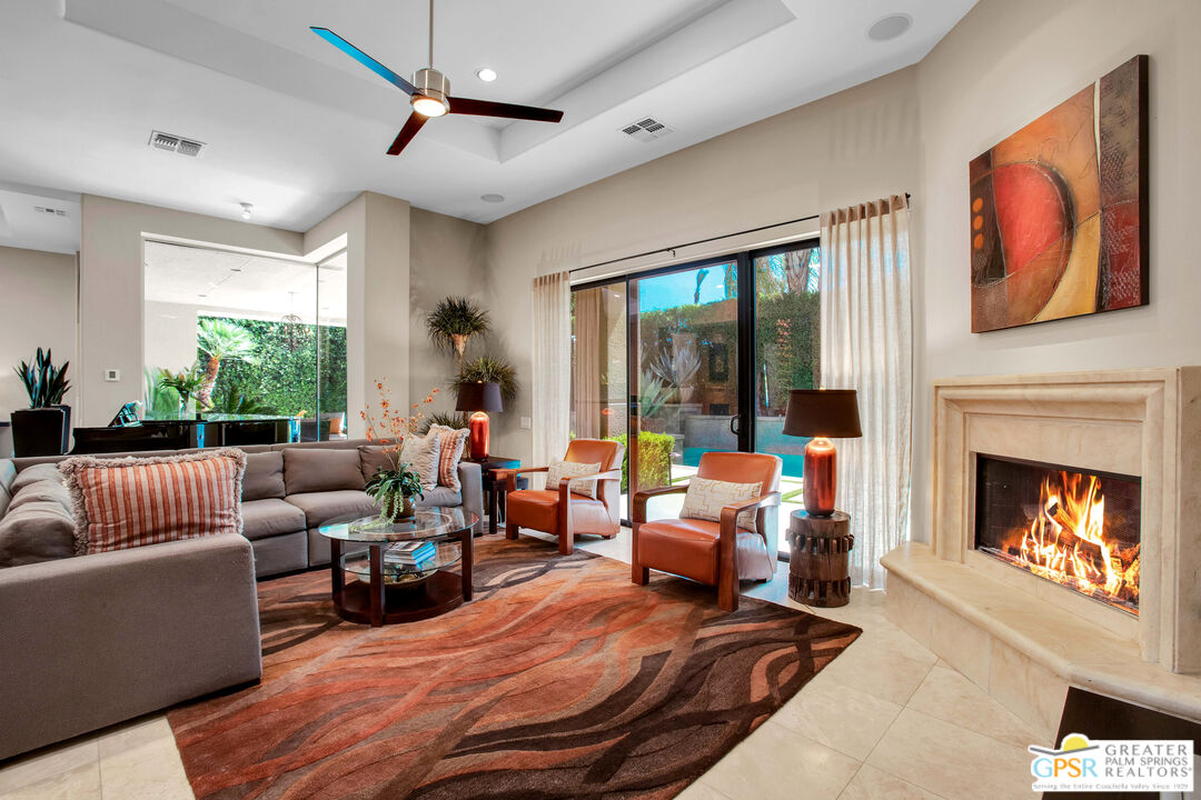 39700 Keenan Drive Rancho Mirage, CA 92270 - Photo 37 of 69 a living room with furniture a fireplace and a large window