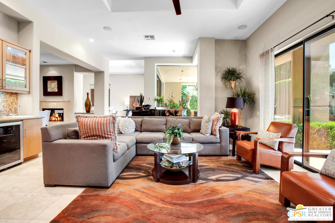 39700 Keenan Drive Rancho Mirage, CA 92270 - Photo 38 of 69 a living room with furniture large windows and a fireplace